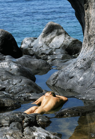 Nude lying on rocks